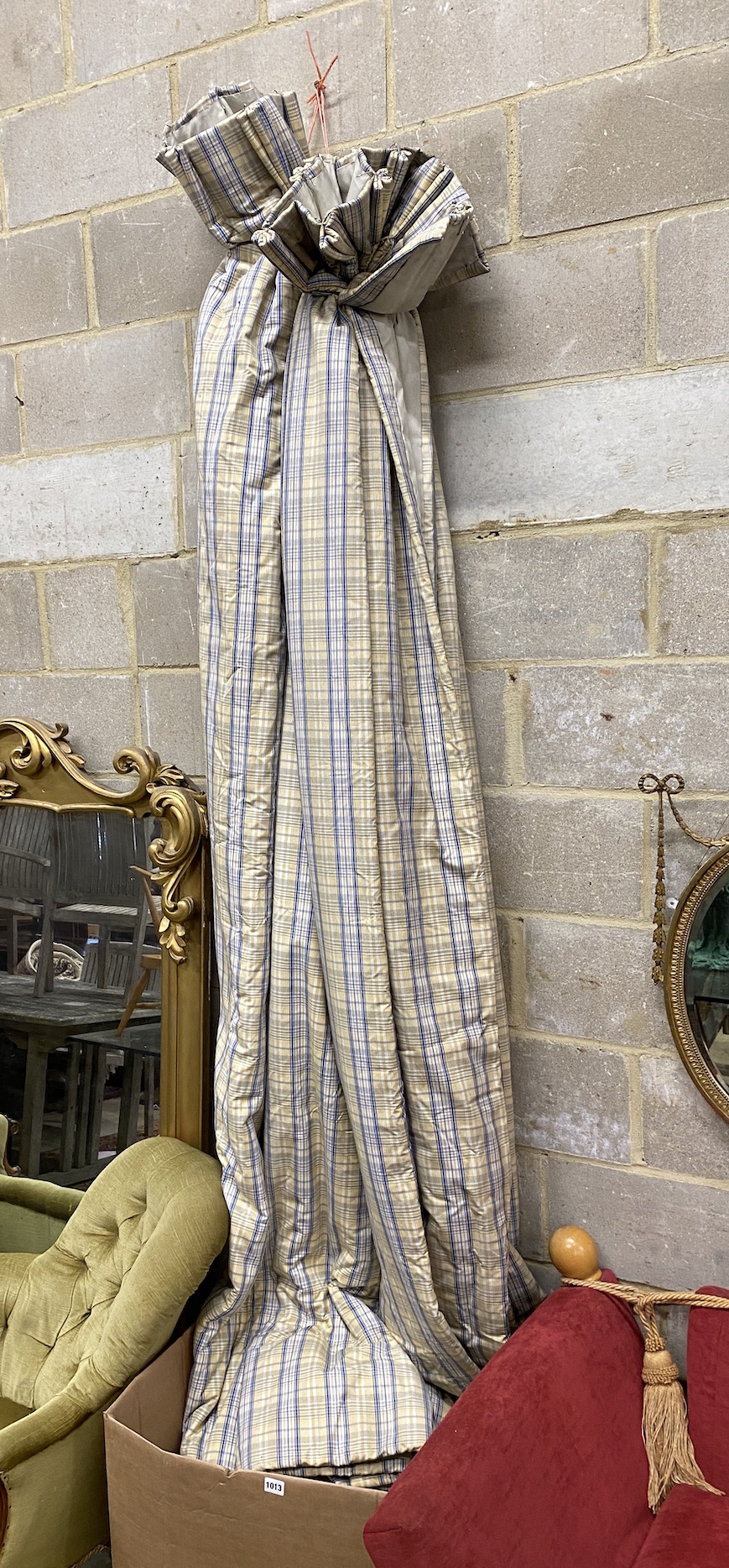 A pair of blue / gold check lined curtains approximate widths 140cm top, 320cm floor, drop 250cm with five matching drapes three cushions and a blue floral bedspread